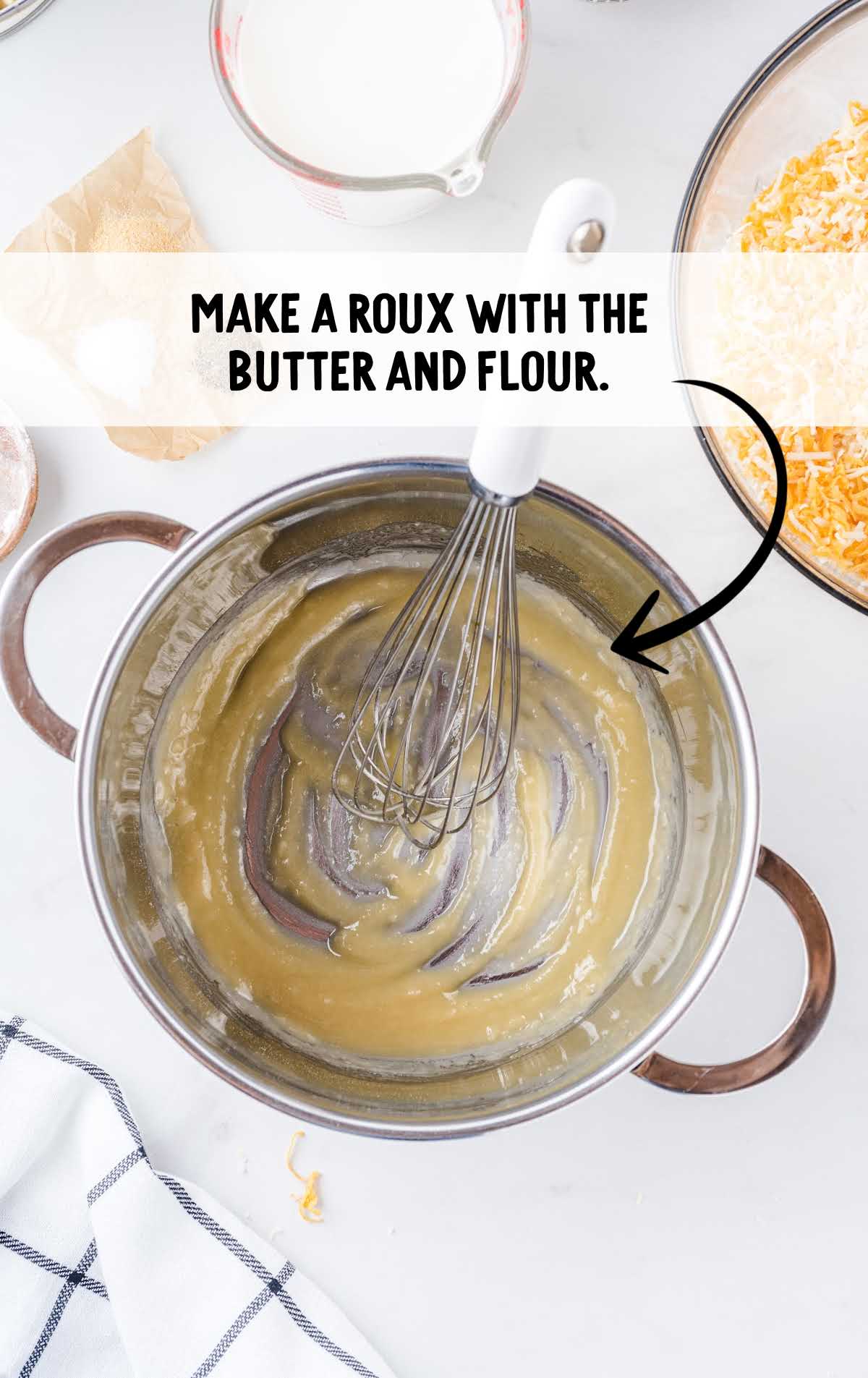 butter and flour whisked together to make roux in a pot