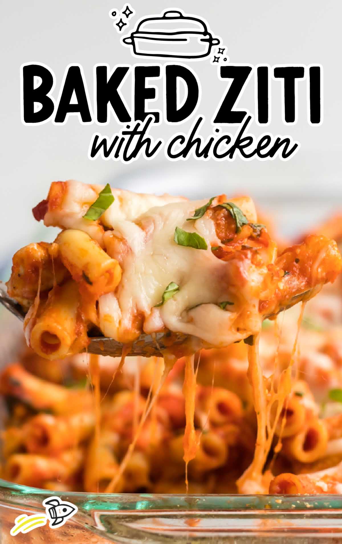close up shot of a baking dish of chicken baked ziti garnished with basil and a spoonful being picked up