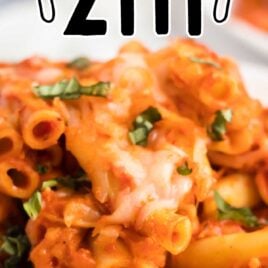 close up shot of a plate of chicken baked ziti garnished with basil