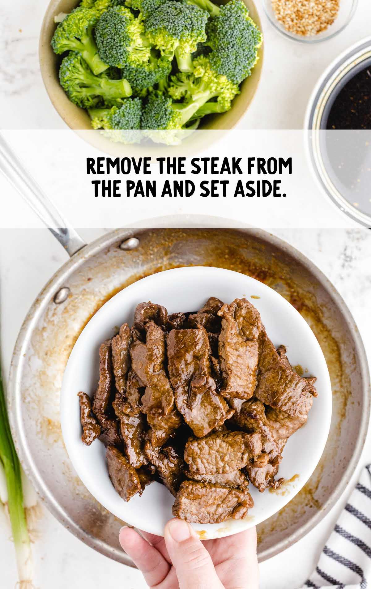 steak on a plate being removed from pan