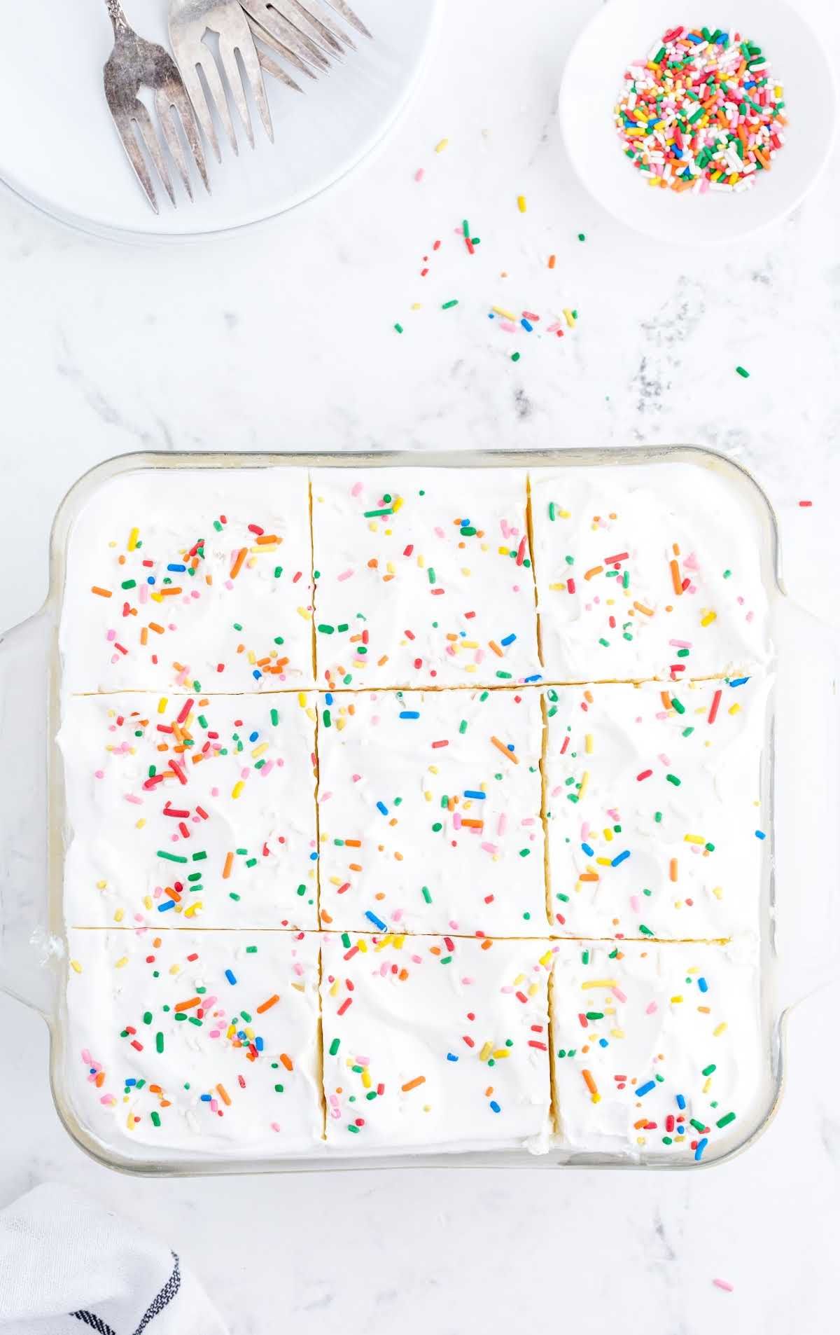 overhead shot of birthday cake delight with sprinkles on top on a baking dish