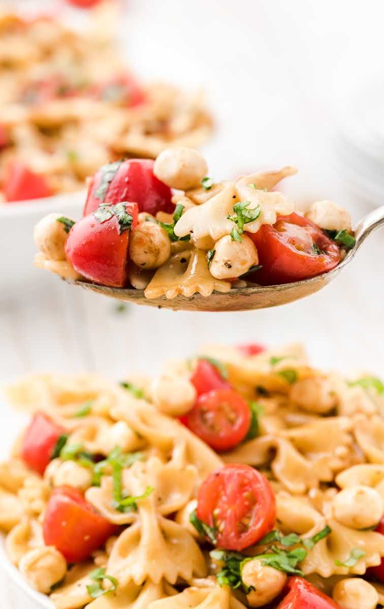 close up shot of Caprese pasta salad on a spoon