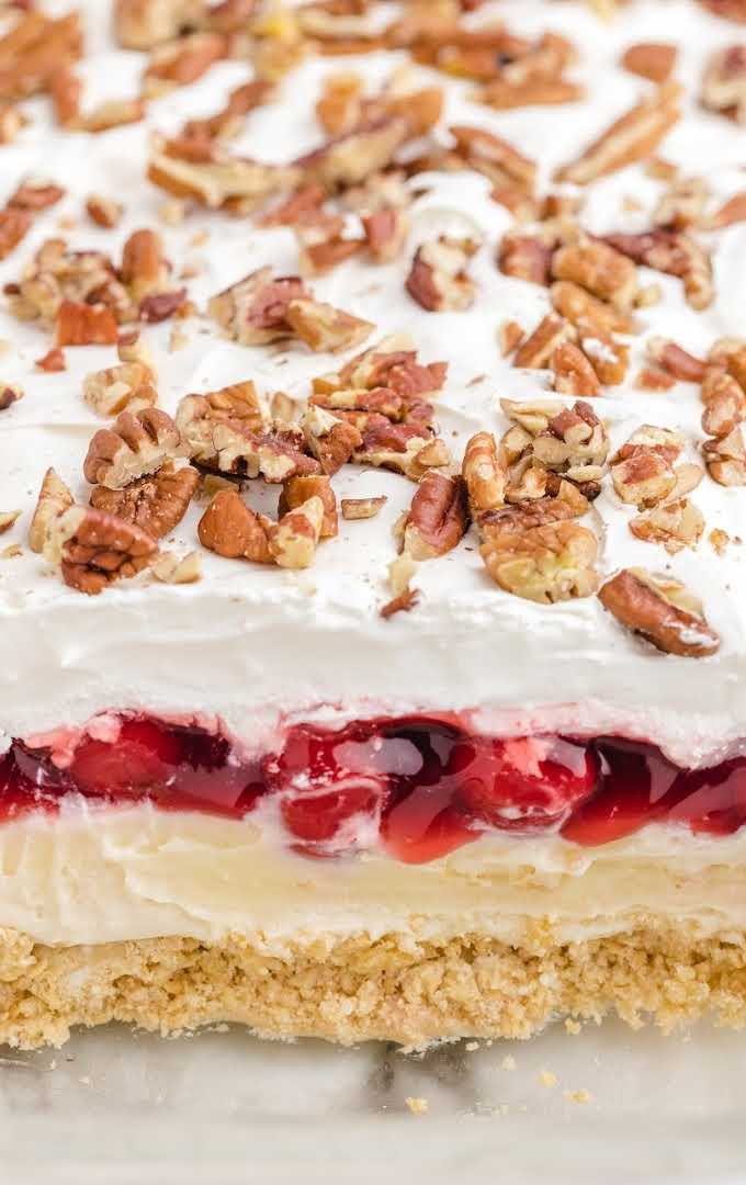 close up shot of cherry cheesecake lush with walnuts on top in a dish