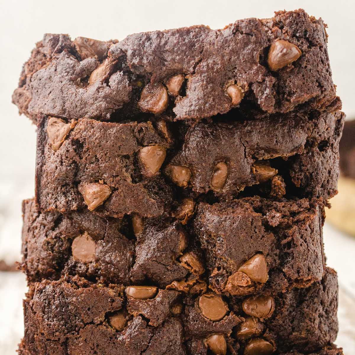 close up shot of slices of chocolate zucchini bread stacked on top of each other