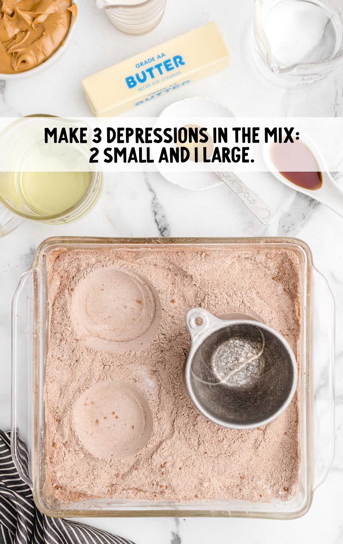 depressions made into the cake in a cake pan