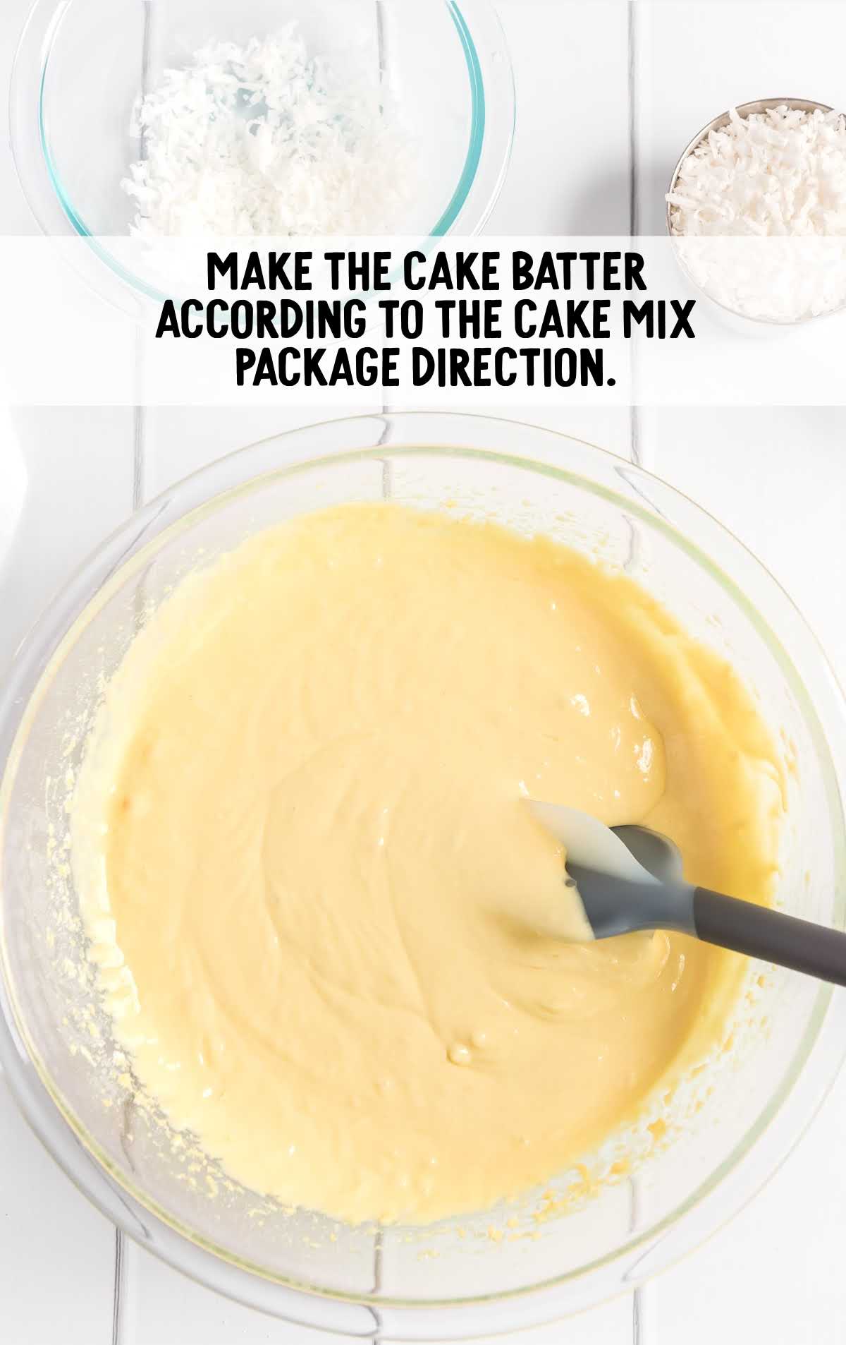 cake batter ingredients being mixed together in a clear bowl