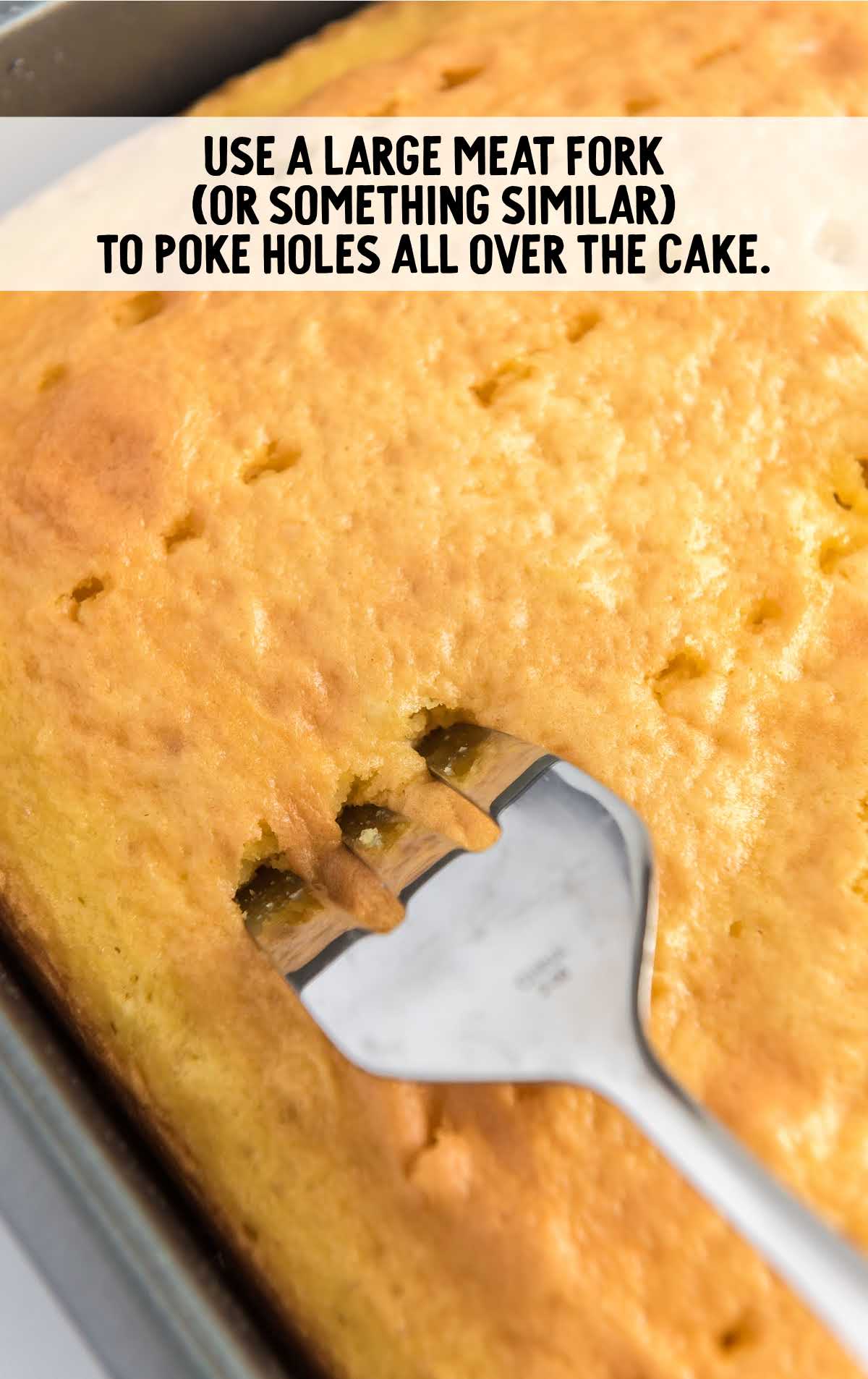 holes poked into the baked cake with a fork