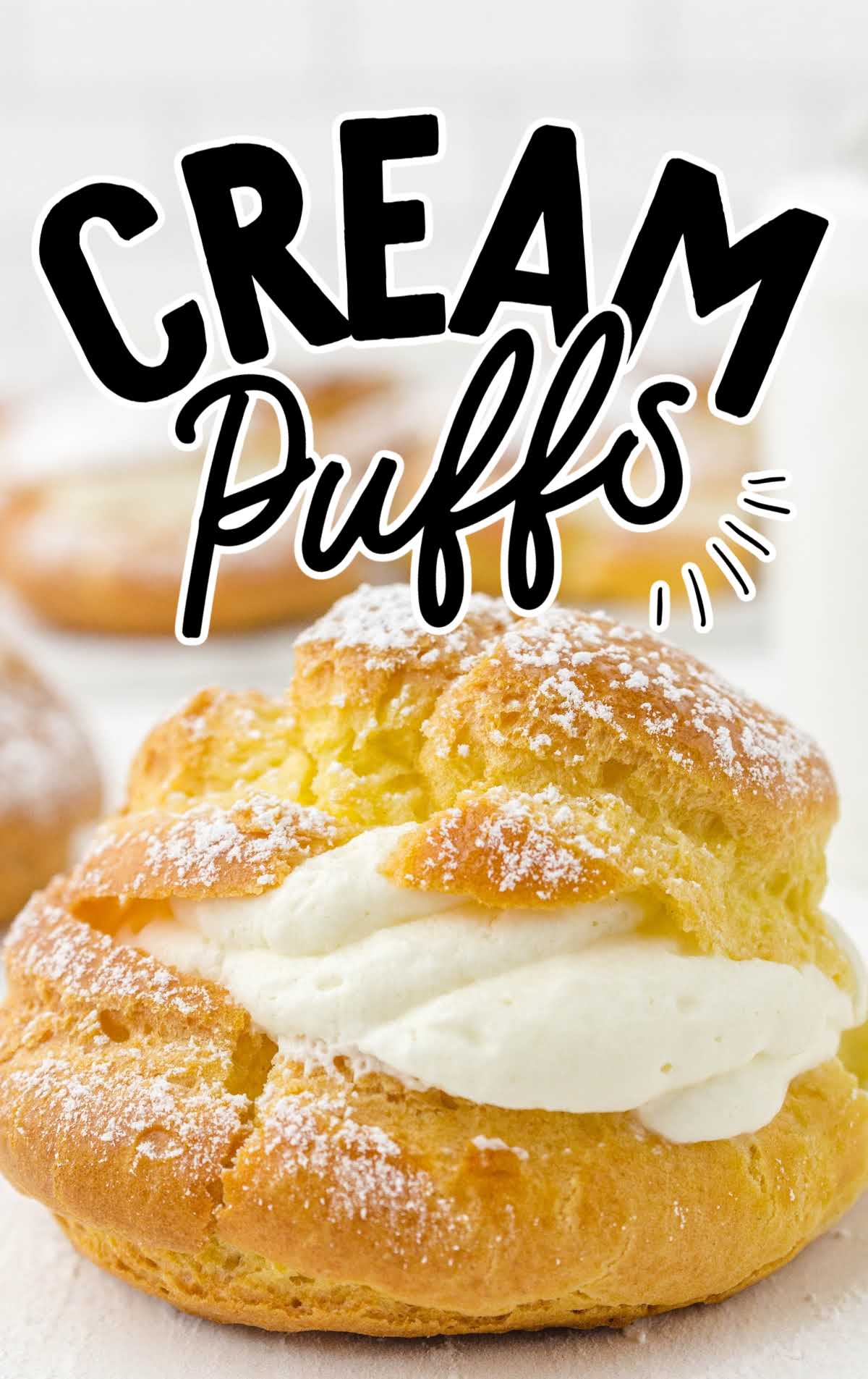 Single cream puff with whipped cream filling and a dusting of powdered sugar, labeled “Cream Puffs.”