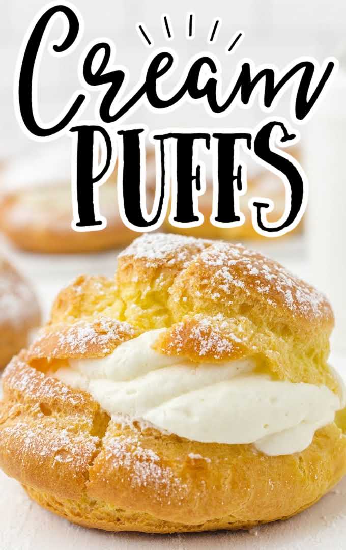 close up shot of cream puffs sprinkled with powdered sugar