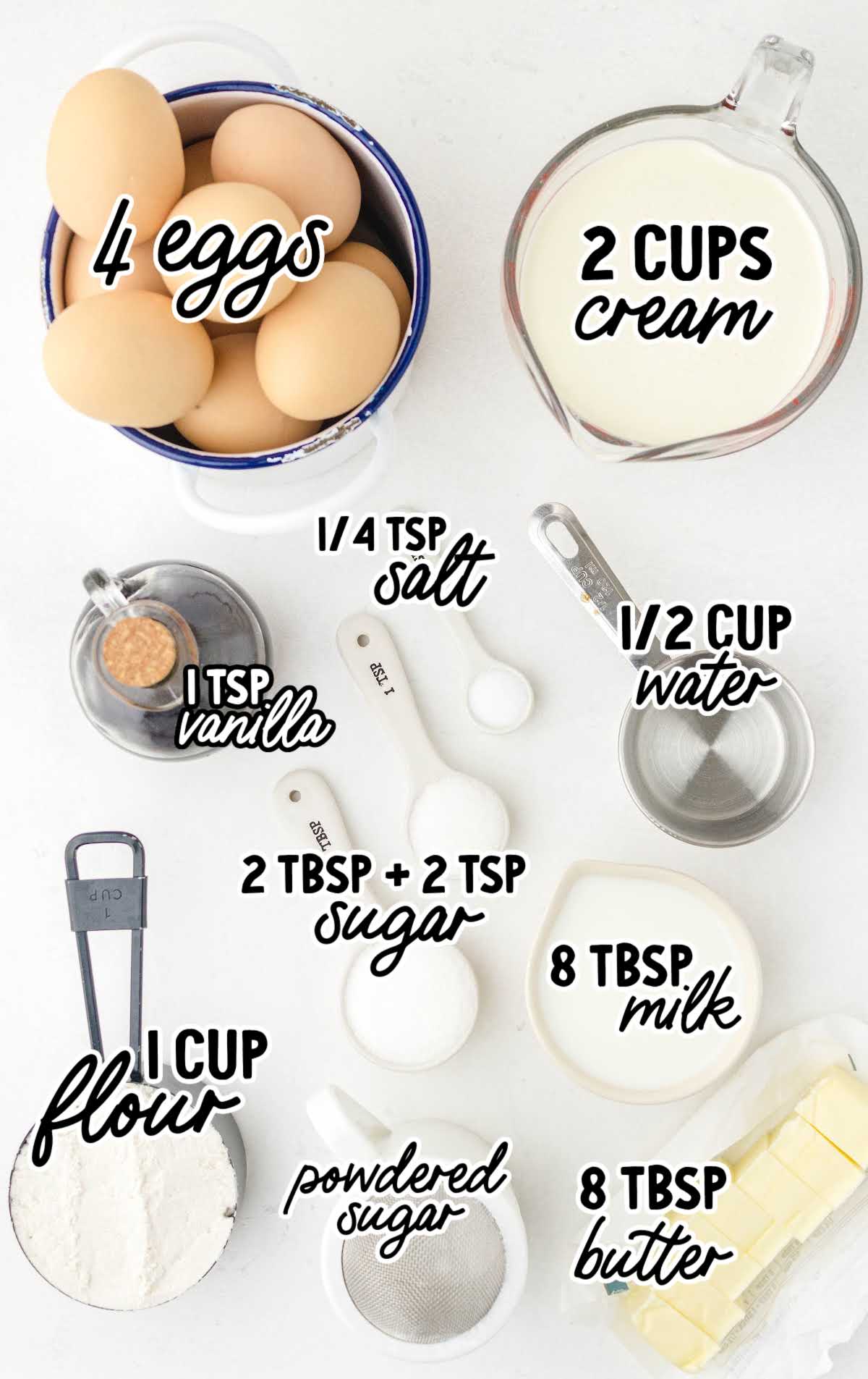 Labeled flat lay of cream puff ingredients including eggs, cream, flour, butter, sugar, and vanilla extract.