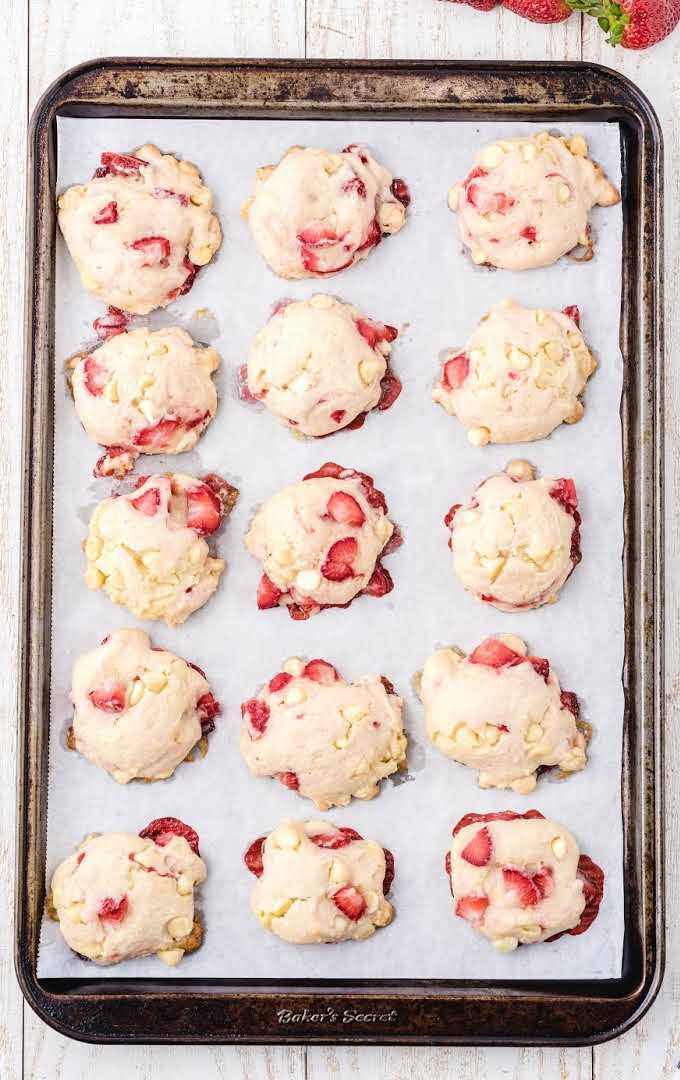 overhead shot of cream cheese strawberry cookies in a sheet pan