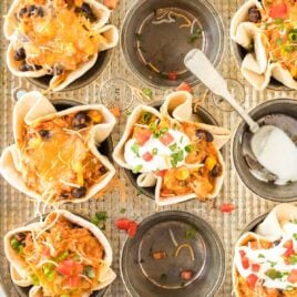 overhead close up shot of Enchilada Cups topped with sour cream