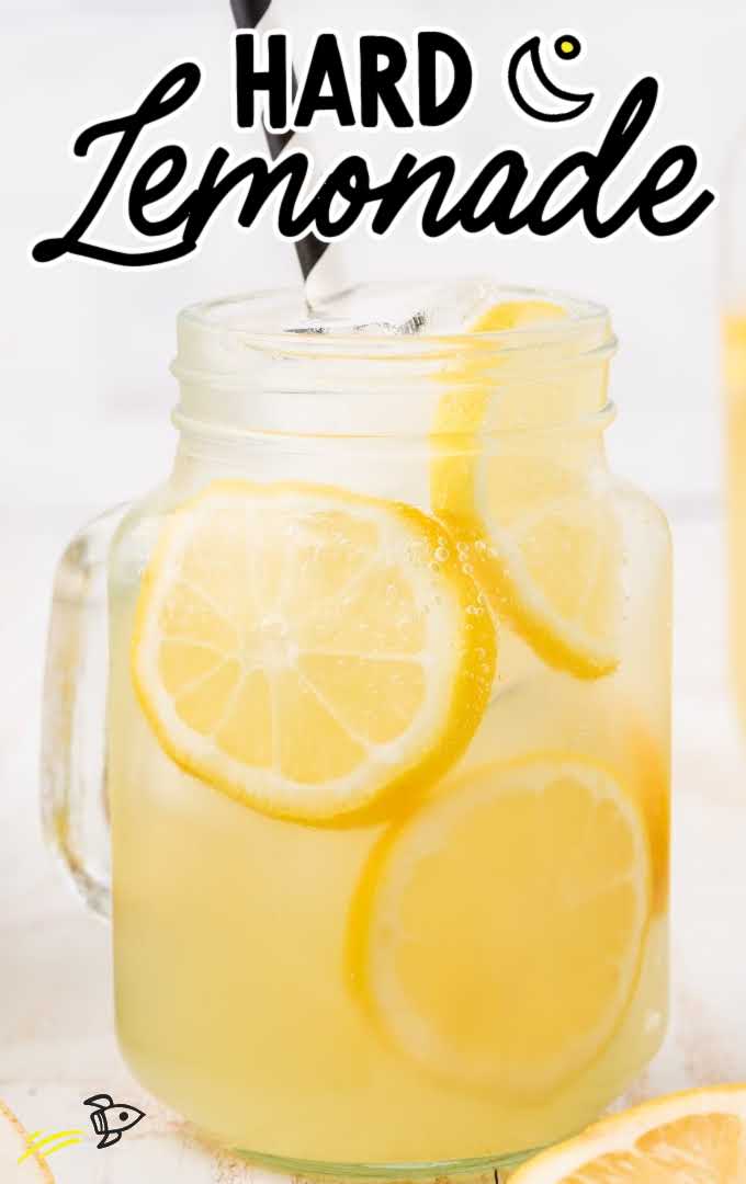 close up shot of hard lemonade in a glass jar with slices of lemon