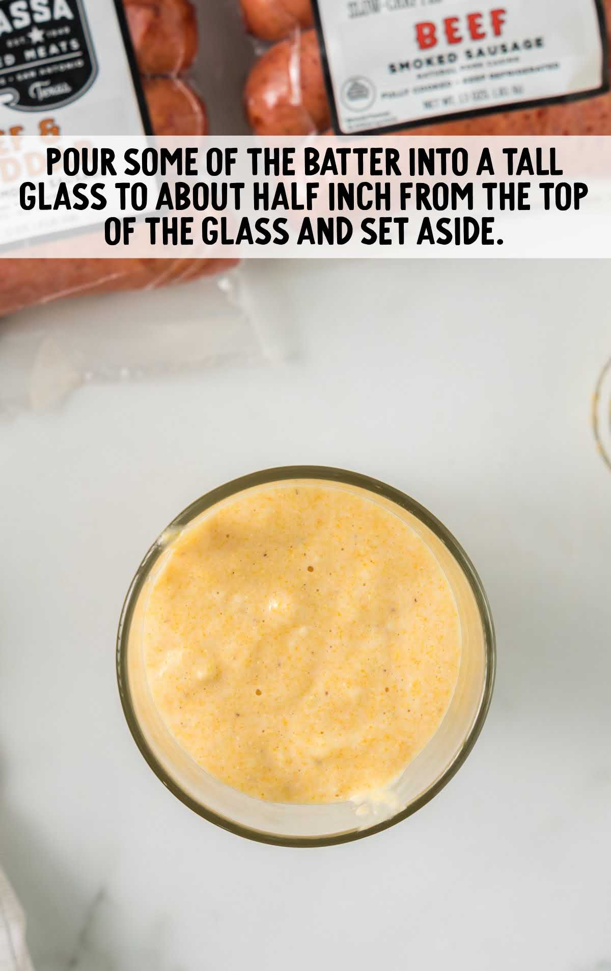 cornmeal batter poured into a tall glass