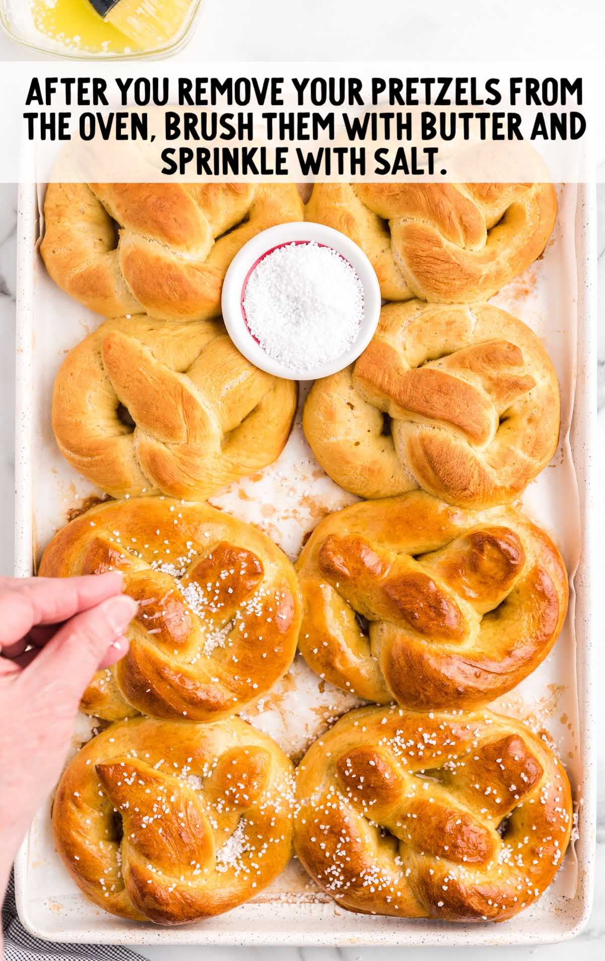 brush pretzel with butter and sprinkle with salt