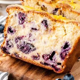 close up shot of slices of Lemon Blueberry Bread on a wooden board