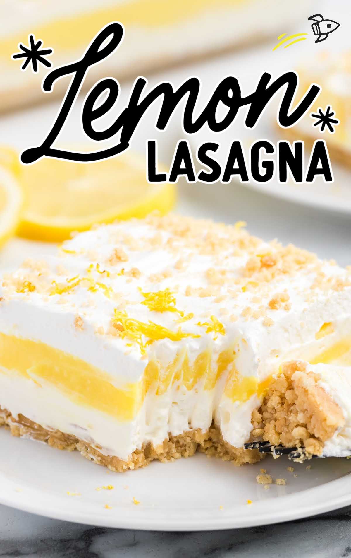 close up shot of a slice of lemon lasagna with a piece taken out of it on a plate