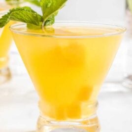 close up shot of Mango Mojito in a glass cup with a mint