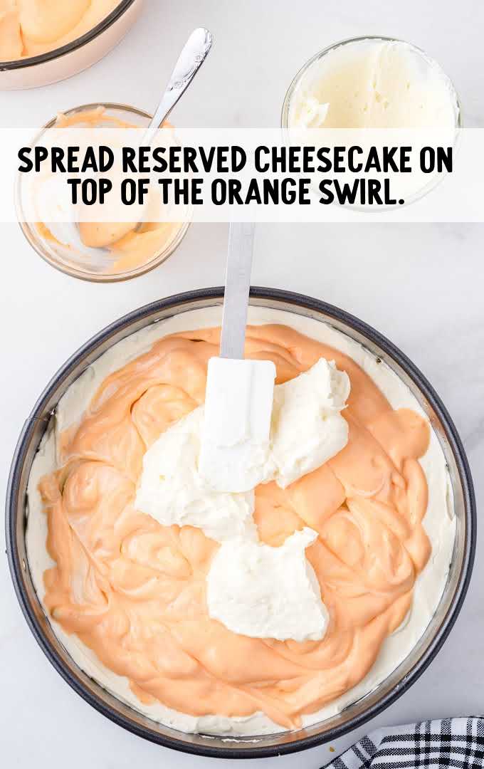 no-bake orange creamsicle cheesecake process shot of cheesecake placed on top of orange cream layer