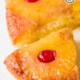 a close up shot of a slice of Pineapple Upside Down Cake being taken out with a spatula