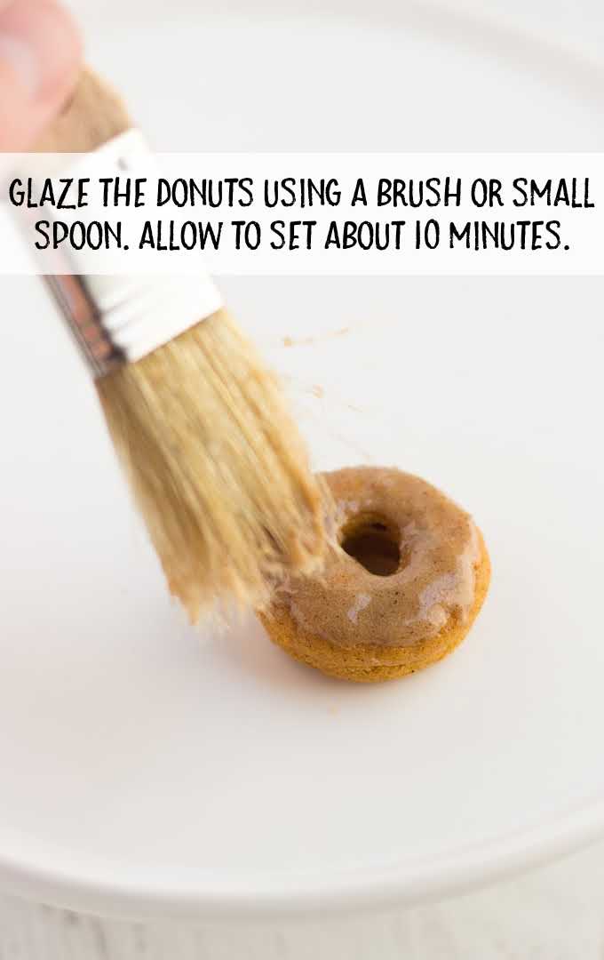 pumpkin donuts process shot of glaze being brushed onto donut