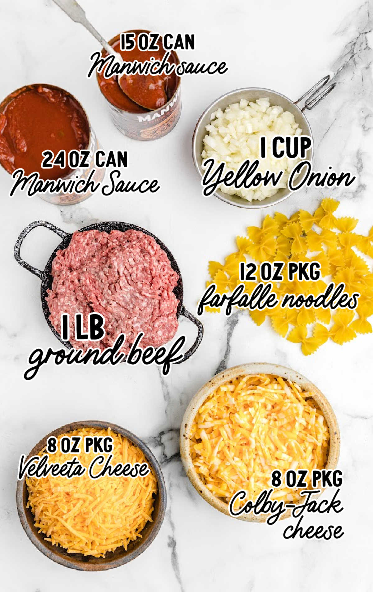 Flat lay of sloppy joe casserole ingredients including Manwich sauce, ground beef, onion, bowtie pasta, Velveeta, and Colby-Jack cheese.