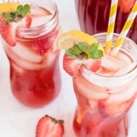 close up shot of glasses of Southern Strawberry Sweet Tea garnished with strawberry an lemon slices