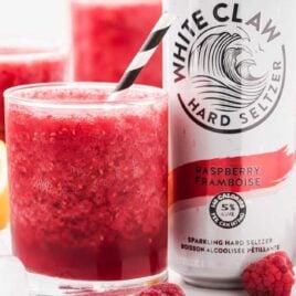close up shot of White Claw slushie in a glass jar with a straw