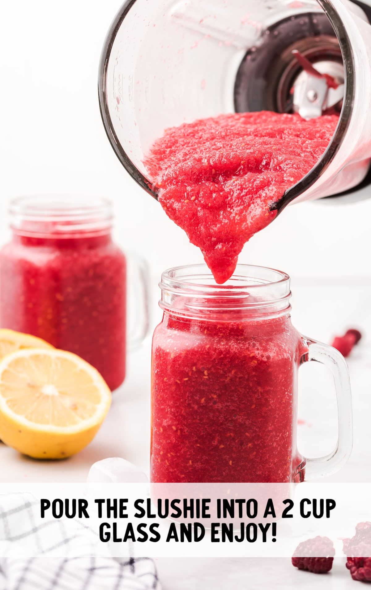 slushie being poured from a blender into a glass jar