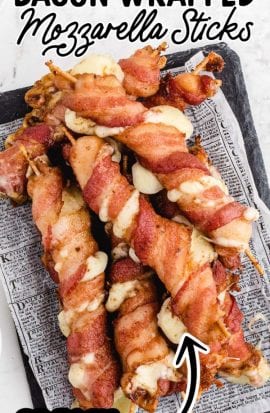 close up shot of bacon-wrapped mozzarella sticks on a piece of paper