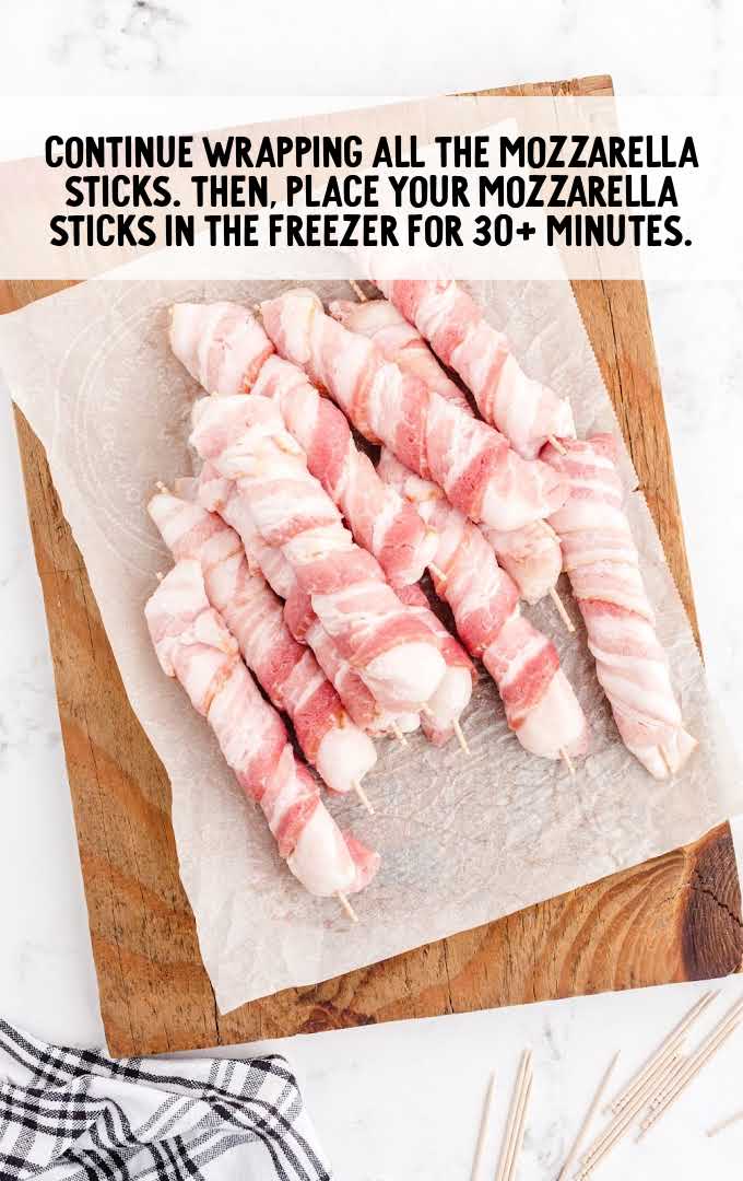 bacon-wrapped mozzarella sticks process shot of bacon wrapped around cheese sticks