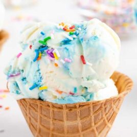 close up shot of Birthday Cake Ice Cream in a waffle cone cup