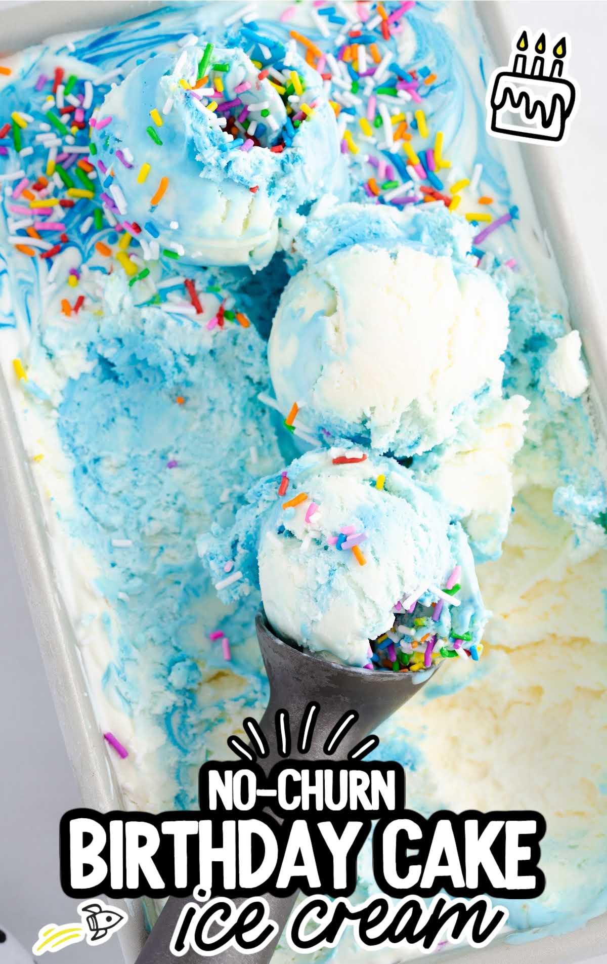 overhead shot of Birthday Cake Ice Cream being scooped out with an ice cream scooper in a baking dish