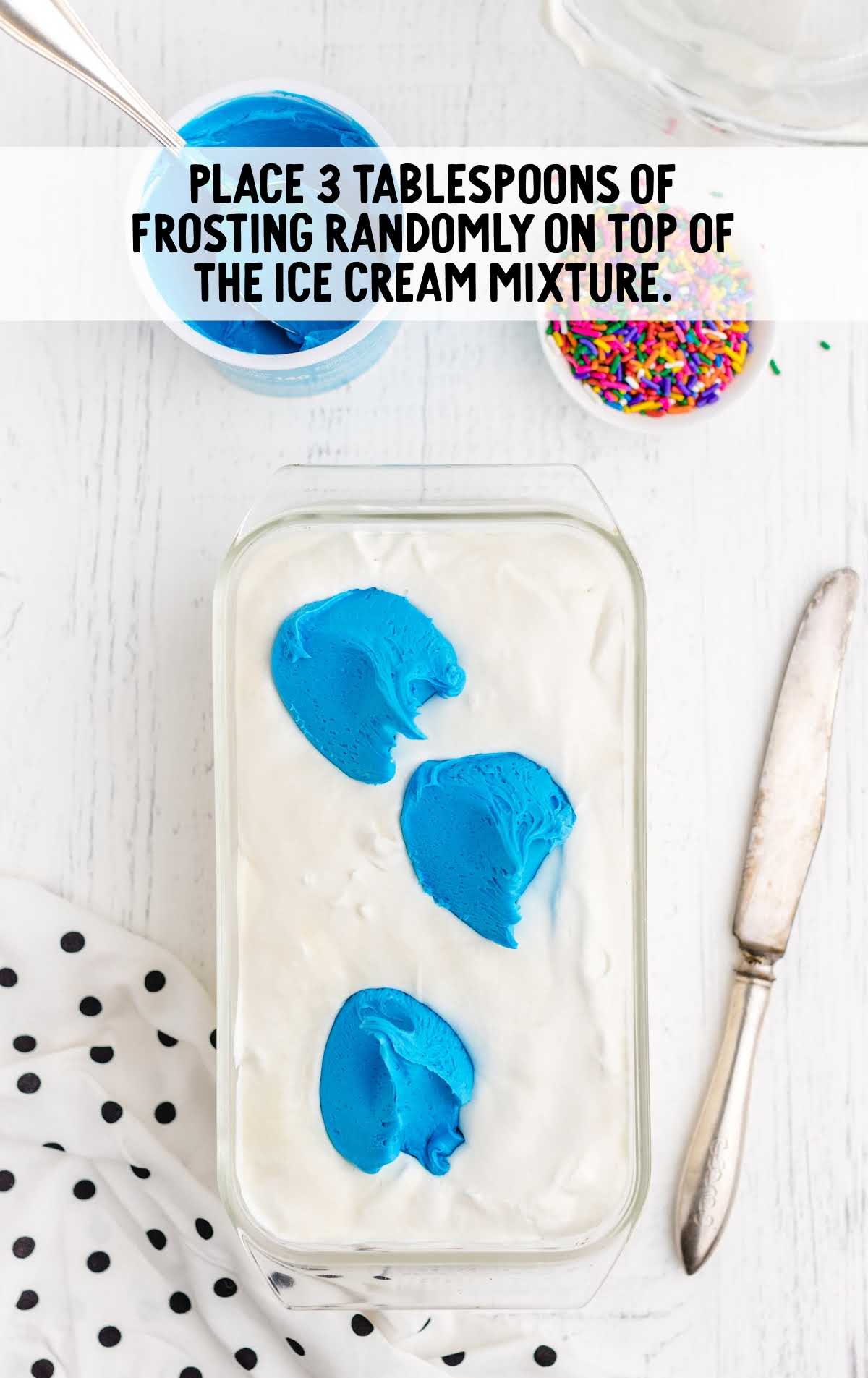 frosting on top of the ice cream mixture in a baking dish