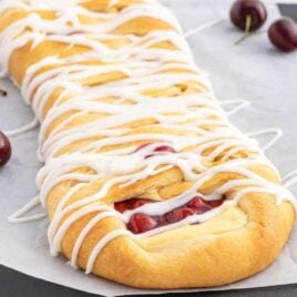 close up shot of cherry breakfast braid surrounded by cherries