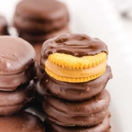 a close up shot of Chocolate Peanut Butter Ritz Cookies stacked on top of each other