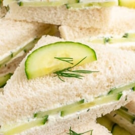 Cream cheese cucumber tea sandwiches labeled as a "Vintage 80s Recipe" with garnish of dill and cucumber on top.