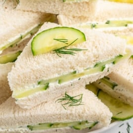 Cream cheese cucumber tea sandwiches labeled as a "Vintage 80s Recipe" with garnish of dill and cucumber on top.