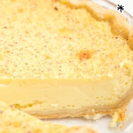 Whole custard pie with a slice removed, showing smooth yellow filling and text overlay that reads “family favorite custard pie”