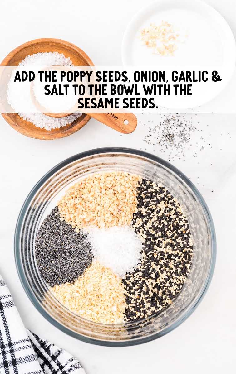 poppy seeds, onion, garlic, and salt added to a bowl with the sesame seeds 