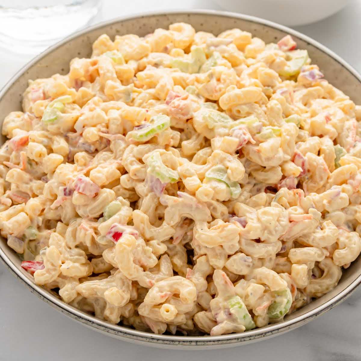 Creamy macaroni salad in a serving bowl.