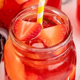 Mason jar of strawberry sweet tea with lemon slices and strawberries, labeled “Deep South Strawberry Sweet Iced Tea – Vintage Recipe!”