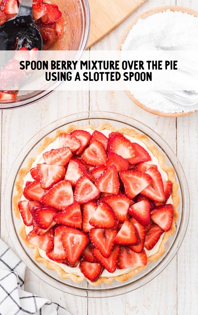 sliced strawberries mixture being topped over pie filling