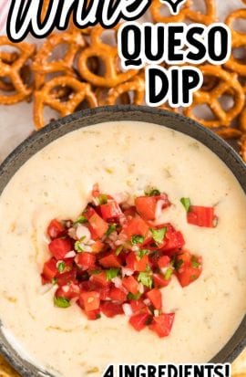 close up overhead shot of a bowl of white queso dip topped with diced tomatoes