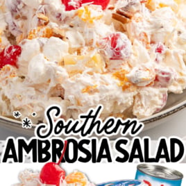 A bowl of Southern Ambrosia Salad topped with cherries, featuring mixed fruit, marshmallows, and cream. Below, cans of mandarin oranges, Cool Whip, and Jet-Puffed marshmallows are shown as ingredients. Vintage Recipe!.
