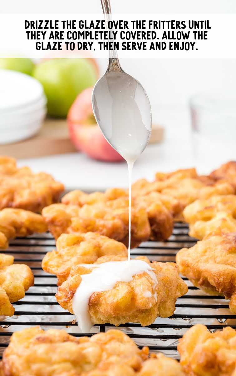 apple fritter recipe process shot of glaze being poured over fritters on a cooling rack