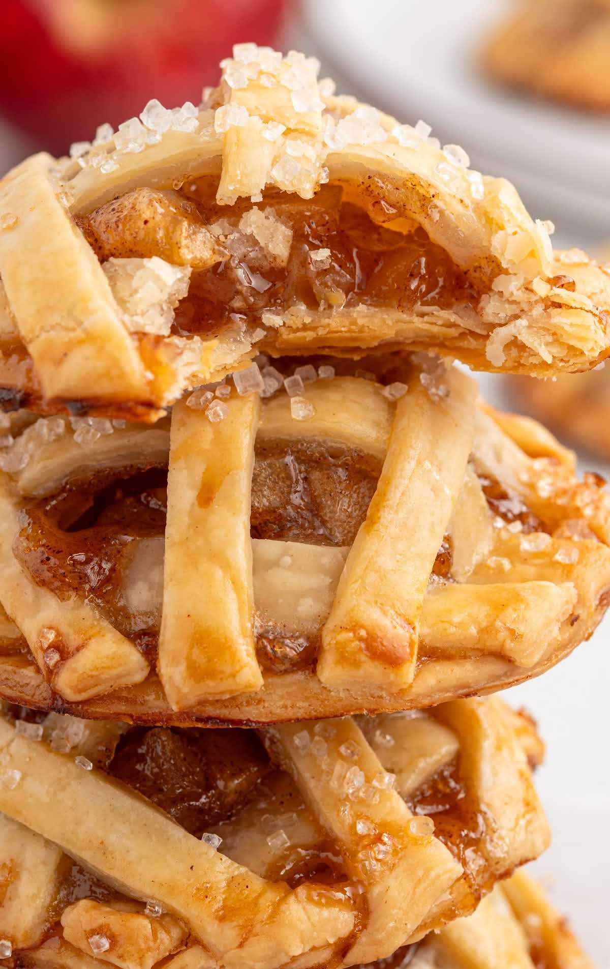 Stack of mini apple pie cookies showing the gooey apple filling inside the crispy crust.