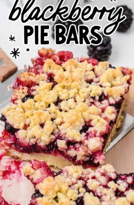 close up shot of Blackberry Pie Bars on a wooden board