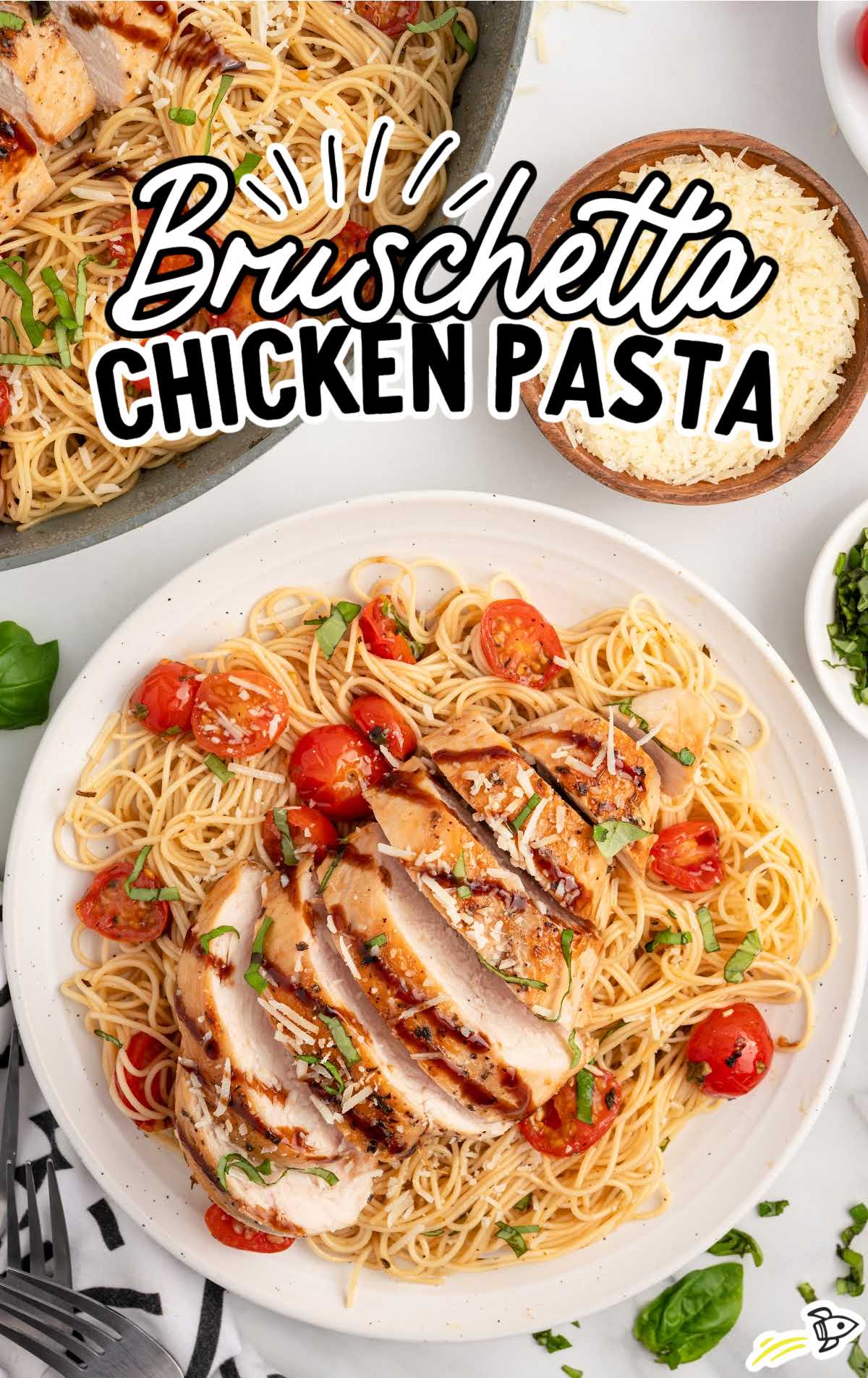 a plate of bruschetta chicken pasta garnished with basil