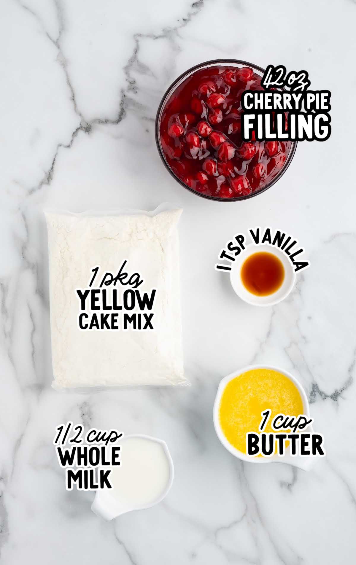Overhead display of ingredients for cherry dump cake, including cherry pie filling, yellow cake mix, vanilla, milk, and melted butter.